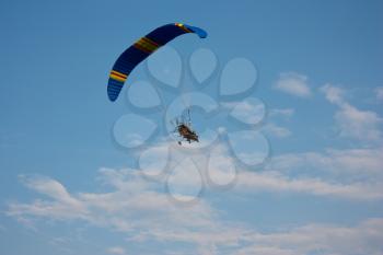 paraglider with a motor in blue sky