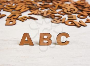 ABC wooden letters on a white background old wooden