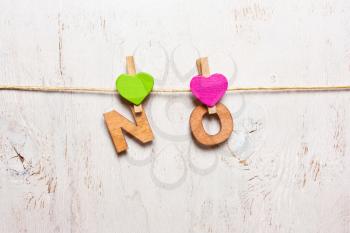 the word no letters on a wooden clothespins on a white background old