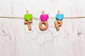 the word top from the wooden lettersn on a white background 