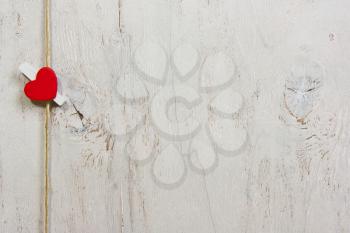 One lovely red heart. On old white wood background.