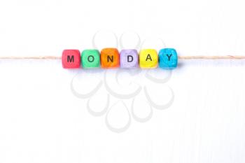 word Monday from multi-colored cubes on a white background