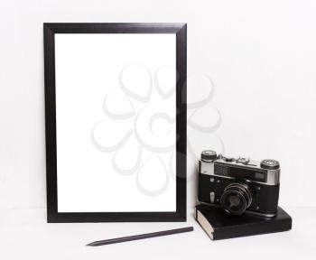 Blank black picture frames on on  white background ,Vintage camera, notebook. Mockup in hipster style workspace