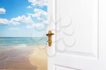 White doors are open to the new world, life, to the beach, the sea and the blue sky. A fantasy concept about rest at work