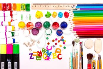 A background of colored pencils, paints. Workplace designer, artist, concept art.  Top view