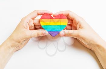 LGBT symbol in hand. Heart of the rainbow color on a white background
