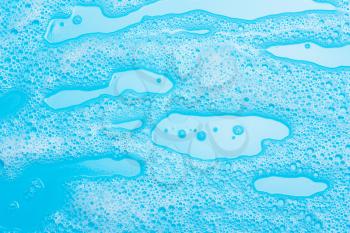 detergent foam, shampoo, soap bubbles on blue background. The concept of cleanliness, cleaning