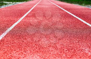 Background of red treadmill, stadium. White lines, stripes