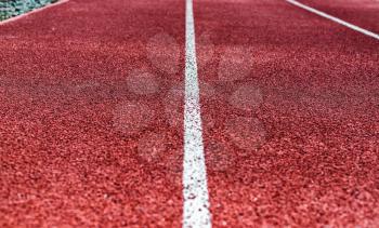 Background of red treadmill, stadium. White lines, stripes