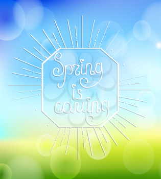 Sunburst with a calligraphical inscription of Its spring is coming on an abstract spring boceh background.