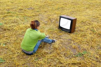 Girl watch TV on the yellow meadow. Element of design