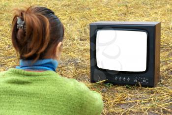 Girl watching TV in meadow. Element of design.