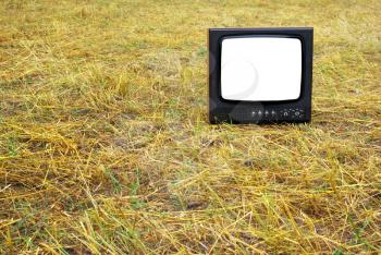 Old television set stand on hay. Conceptual design. 