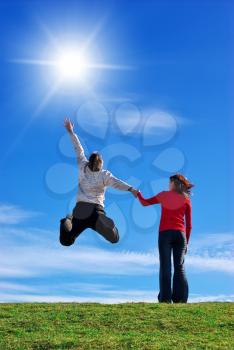 Love to Sun. Couple on meadow and sunny sky.