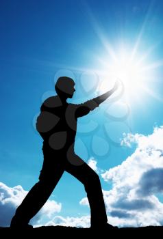 Man touch sun. Conceptual design.