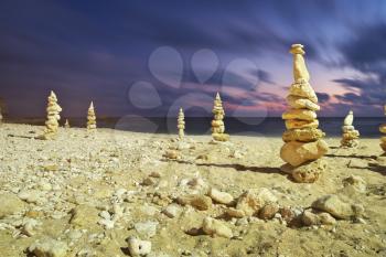 Stone towers on the sea shore. Balance composition.