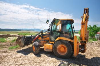 Excavator workimg on the ground. Building design.