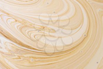 Close-up abstract caramel shapes latte art in coffee. Liquid texture background macro.