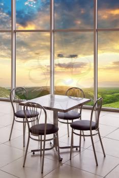 Table, chairs and nature mountain sunset. Restaurant element of design.