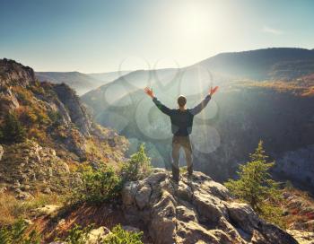 Man standing on the cliff. Conceptual scene. Mountain nature composition. 