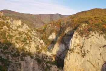 Autumn mountain view with sunshine and haze into canyon. 