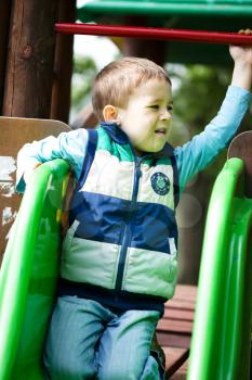 Cute little boy is playing on playground