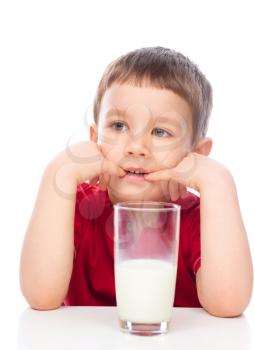 Cute little boy drinks milk using a drinking straw, isolated over white
