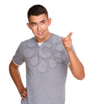 Cheerful young man showing thumb up sign, isolated over white