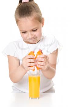 Cute girl is drinking orange juice using straw, isolated over white