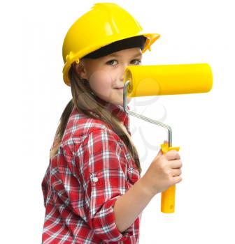 Happy cute girl as a construction worker with paint roller, isolated over white