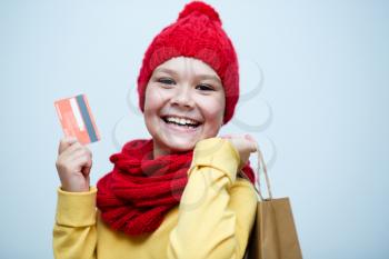 Shopping, sale, holiday concept - smiling girl with shopping bags and plastic card