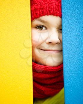 Cute happy girl is playing on playground, outdoor