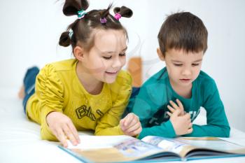 Happy children is reading book