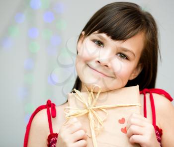 Happiness, health and love concept - smiling girl with red heart