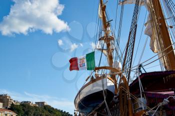 Sailboat with lowered the sail near pier of the city of Ancona. Italy