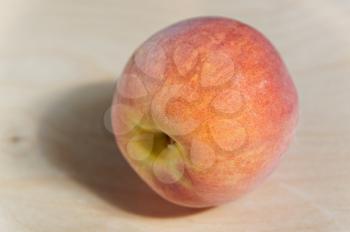 Juicy ripe peach with Golden sideways on a wooden table
