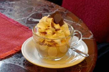 White porcelain Cup with gourmet coffee and ice cream on marble table in Italian bar. A feast for the sweet tooth.