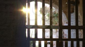 Glare of sunlight through bars  ancient gates old fortress