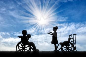 Children with disabilities in wheelchair playing ball. Concept of children with disabilities