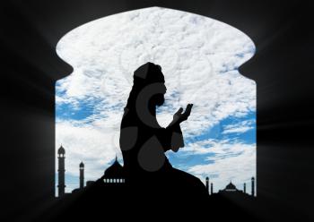 Islamic religion. Muslim praying in a room on the background of the mosque