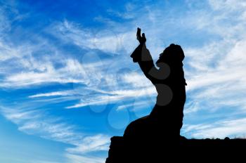 Islamic religion. Muslim prays on a hill against the sky