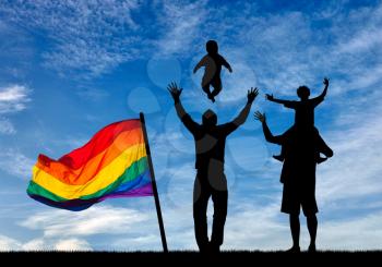 Concept of gay parents. Silhouette of happy gay parents with children on the background of the sky with a rainbow flag