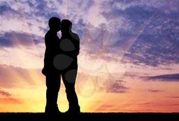 Concept of gay people. Silhouette happy gay kissing against the evening sky