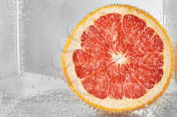 Cut grapefruit in water. design element