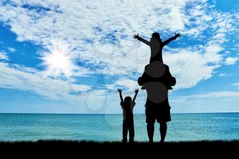 Concept travel. Silhouette of a family against the backdrop of the sea and the beautiful sky