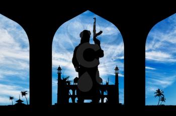 Concept of terrorism. Silhouette of a terrorist with a weapon on the background of the town hall