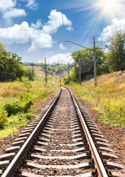 Concept of tourism and travel. The railway passing through a beautiful landscape in the summer