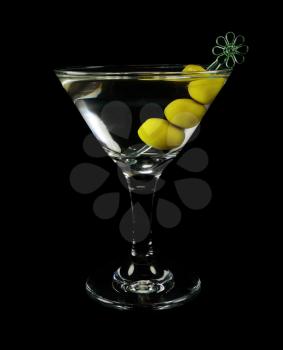 Martini cocktail with olives on a black background closeup