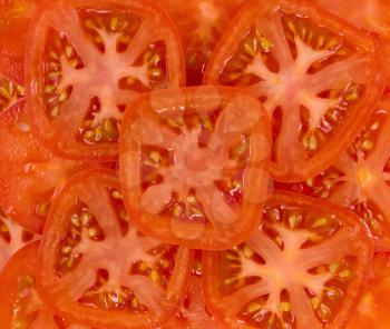 Cut red tomato slices. Close-up background texture