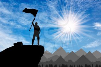 Silhouette of a climber on a mountain top with a flag in his hand. success concept